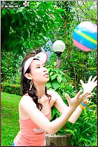  olive moon playing with ball in garden wearing sun visor and orange top