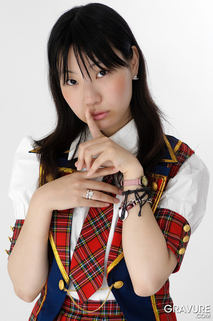 Momoko miura finger raised to lips long hair down over her shoulders wearing white whirt plaid tie and skirt