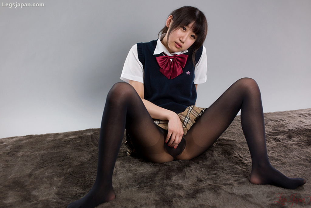 Oshima karina seated in uniform plaid skirt raised over her pantyhose hand between her spread legs