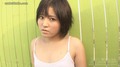 Yuki standing against green fence wearing white ship short hair.jpg